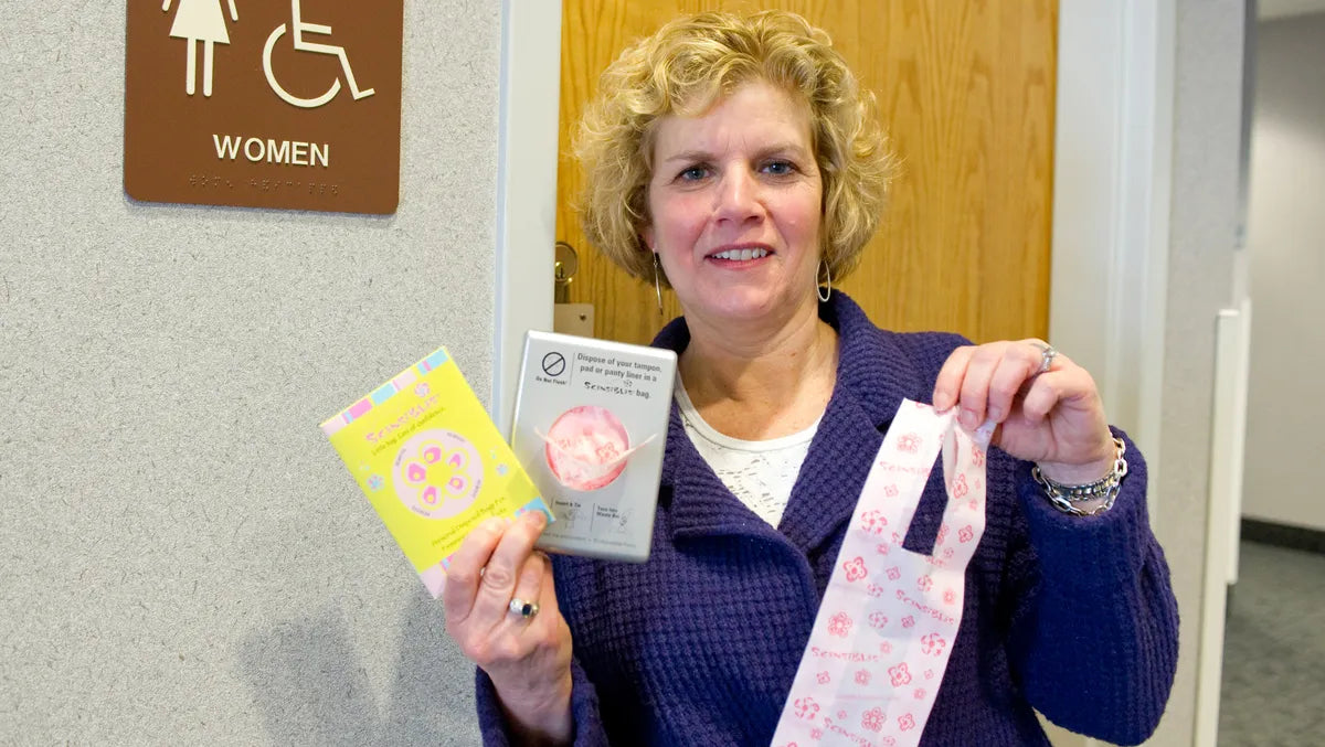 Scensibles founder Ann Germanow holding early disposal bag packaging