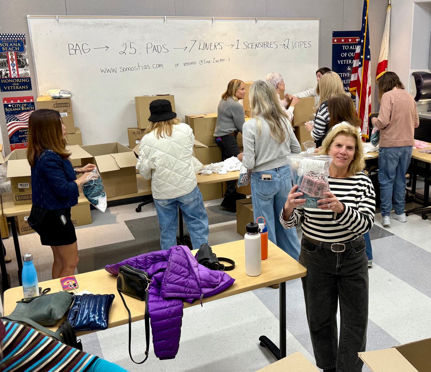Scensibles founder Ann Germanow with volunteers packing period-care products