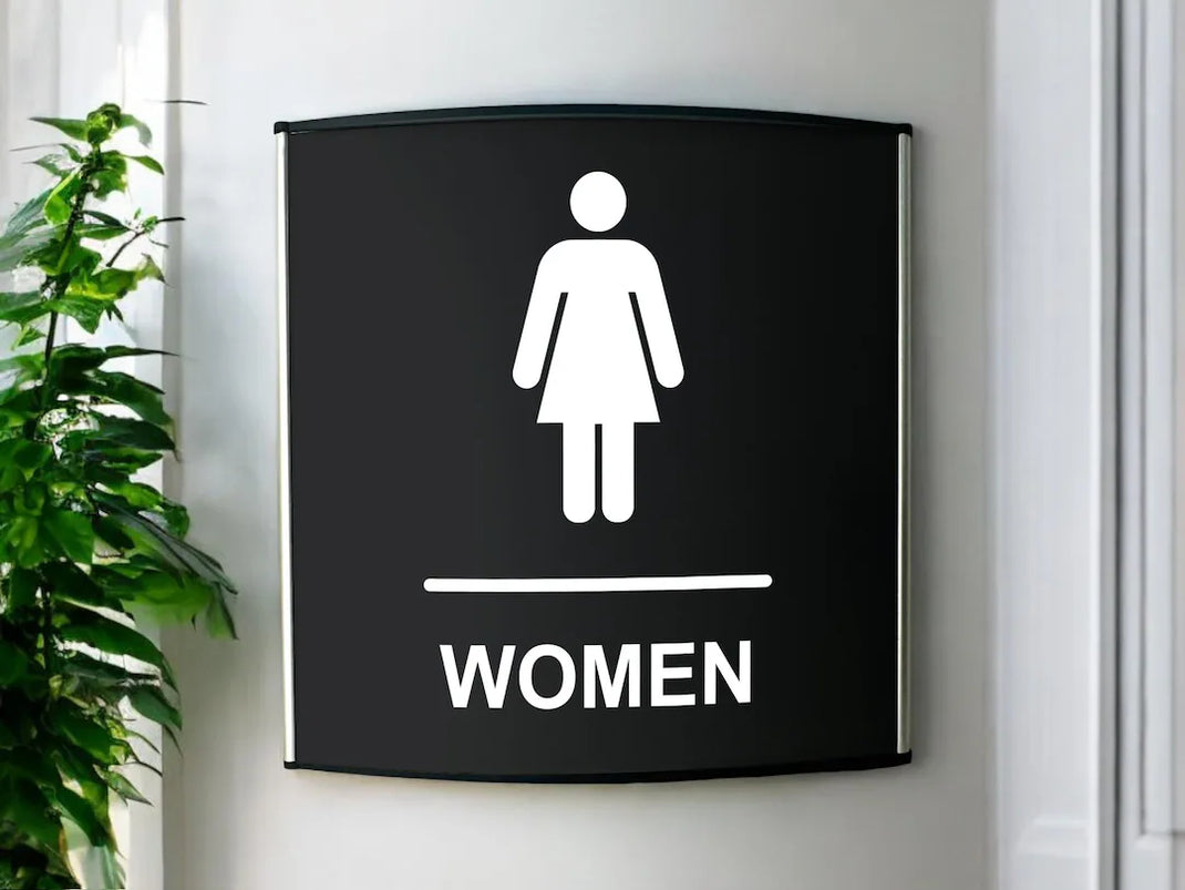 Women's restroom sign in a bright facility